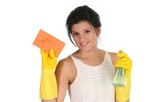 Technician wearing protective gloves and footwear during carpet cleaning